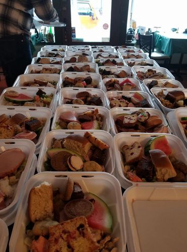 (Open food containers):A close-up look at the delicious, filling plates prepared with love, care, and dignity.