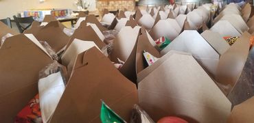 (Packed brown bags):Meals boxed up, packed, and ready to be handed out to anyone who needs one.