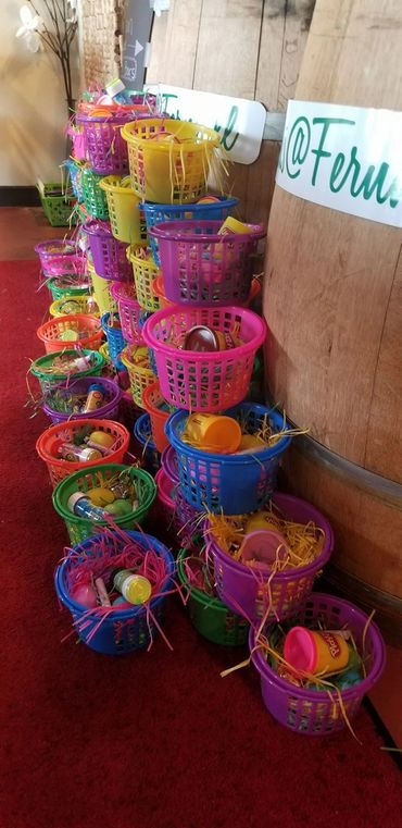 (Easter baskets):Bright and cheerful Easter baskets lined up and waiting to bring joy to local youth and families.