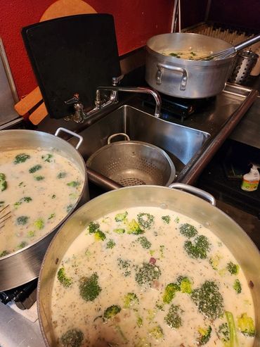 Working side-by-side to hand-prepare fresh ingredients from scratch.