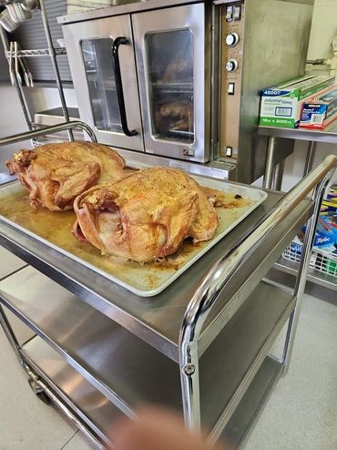 Perfectly golden roasted turkeys fresh out of the oven and ready to serve.