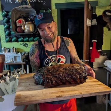 Chef Shawn Tibbitts inside Tibbitts @ Fern Hill preparing prime rib for guests.