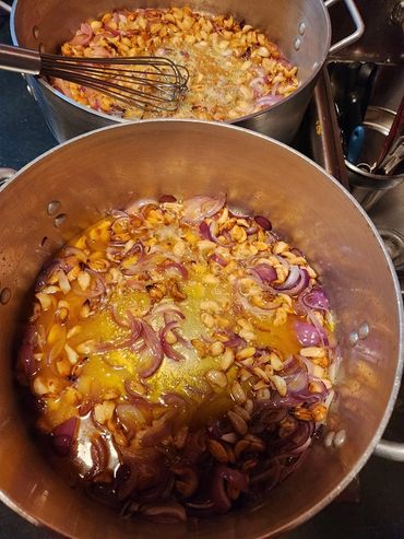 Fresh ingredients simmering on the stove, preparing a hearty community meal from scratch.