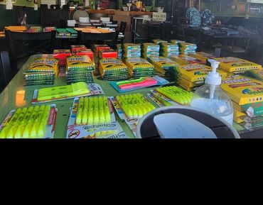 Brightly packaged school supplies and essentials lined up for local families.