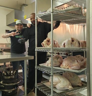 Racks of food prepped and ready to cook for a massive local feed.